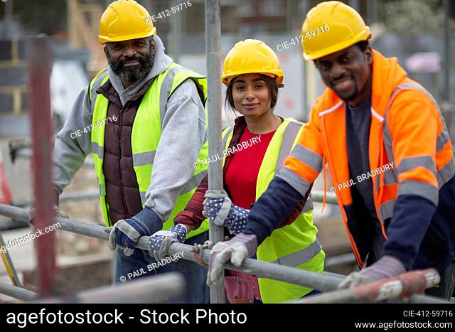 Portrait confident construction workers at construction site
