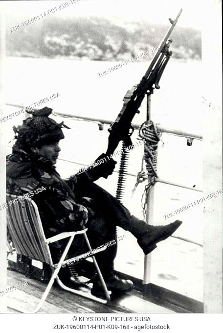 1976 - In San Carlos Bay a British marine keeps watch, machine gun at the ready on the deck of one of the Task Force ships