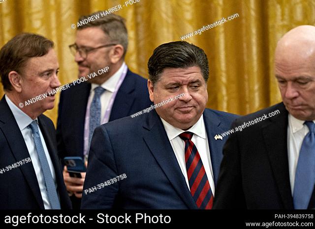 Governor J.B. Pritzker (Democrat of Illinois), center, attends the National Governors Association Winter Meeting in the East Room of the White House in...