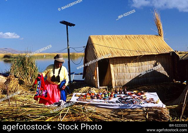 Uro woman with souvenirs on floating island 'Chumi' constructed from totora reeds, Uro woman with souvenirs on floating reed island, Lake Titicaca, Uru, Urus