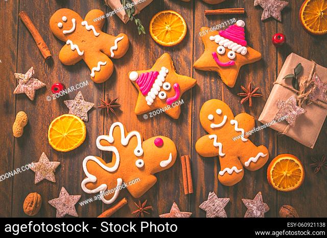 Gingerbread cookies with traditional spices for Christmas time on wooden table