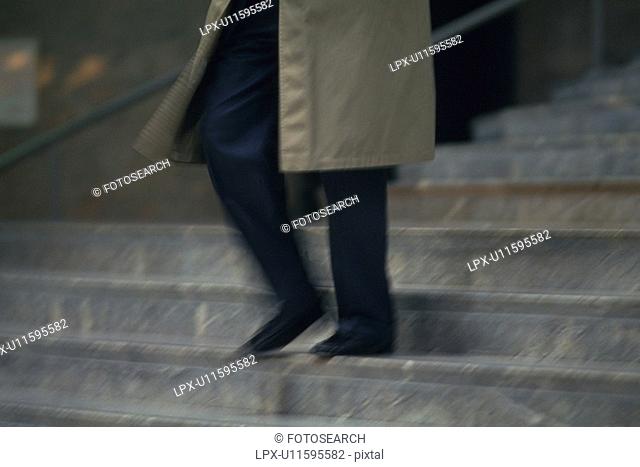 Businessman walking down the stairs, low angle view, blurred motion, New York City, NY, USA