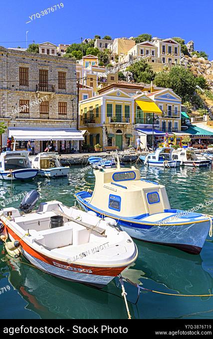 Small fishing boats along the waterfront of Symi Town, Gialos, Symi Island, Dodecanese, Greece