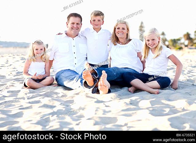 Happy caucasian family at the beach one sunny afternoon