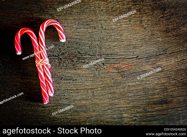Christmas candy canes on a wooden background with copy space