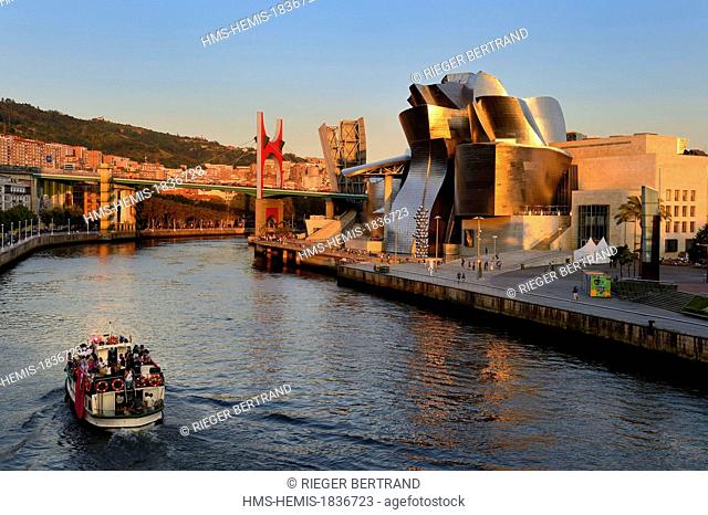 Spain, Basque Country Region, Vizcaya Province, Bilbao, the Guggenheim Museum designed by Frank Gehry and the Salve bridge with Les Arches Rouges artpiece by...