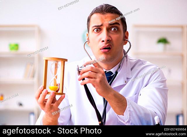 Young doctor in time management concept