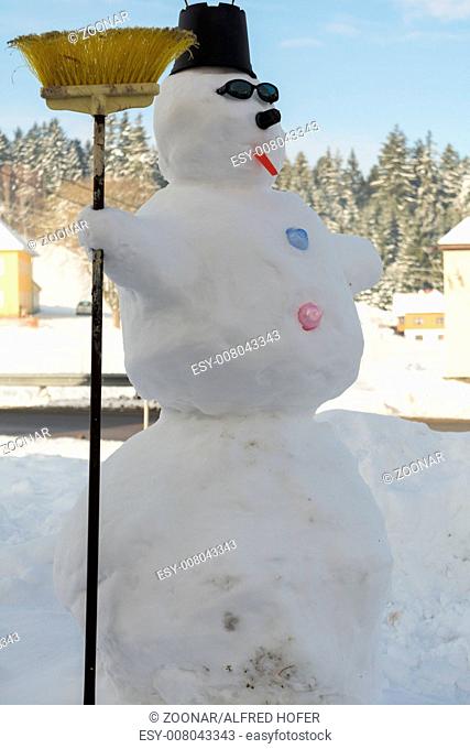large snowman shows off in winter landscape