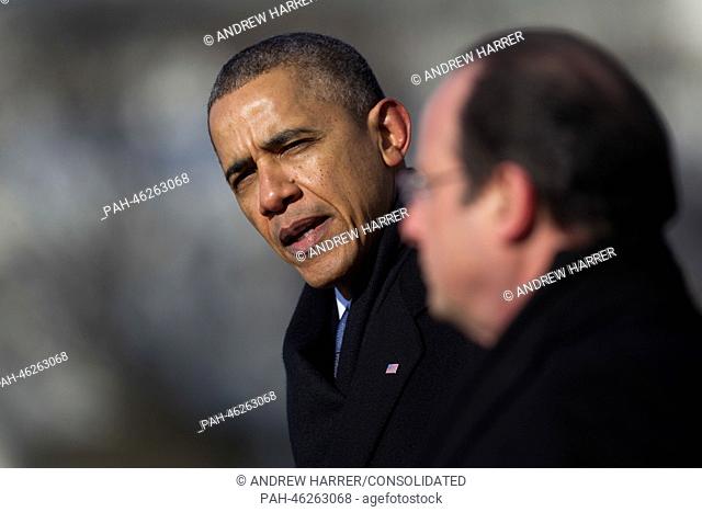 United States President Barack Obama (L) speaks during an arrival ceremony with President Francois Hollande of France on the South Lawn of the White House in...