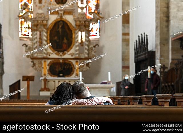 26 March 2022, Saxony-Anhalt, Merseburg: A visitor couple enjoys the silence in the cathedral. Twice a year, Merseburg Cathedral opens its doors to the people...