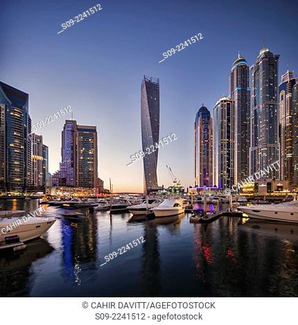 Dubai Marina at twilight with the Cayan Tower (Infinity Tower), the Dubai Marriott Harbour Hotel and Suites and various residential towers, Dubai Marina, Dubai