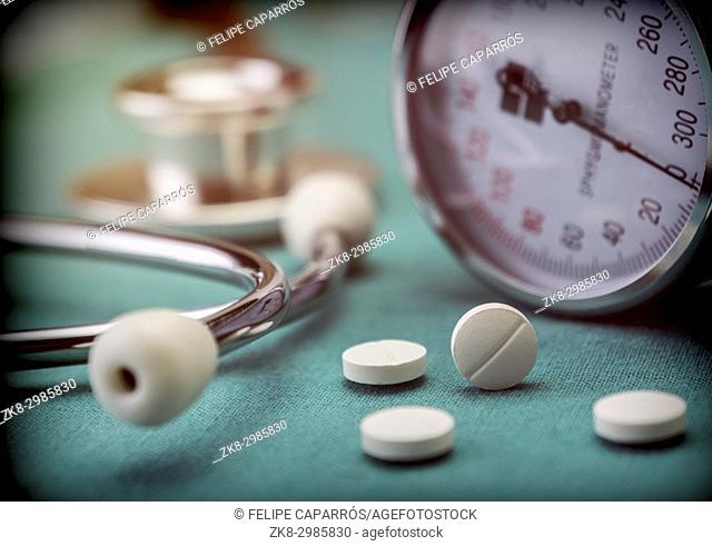 White pad next to a manometer to measure blood pressure and a stethoscope in a hospital, conceptual image
