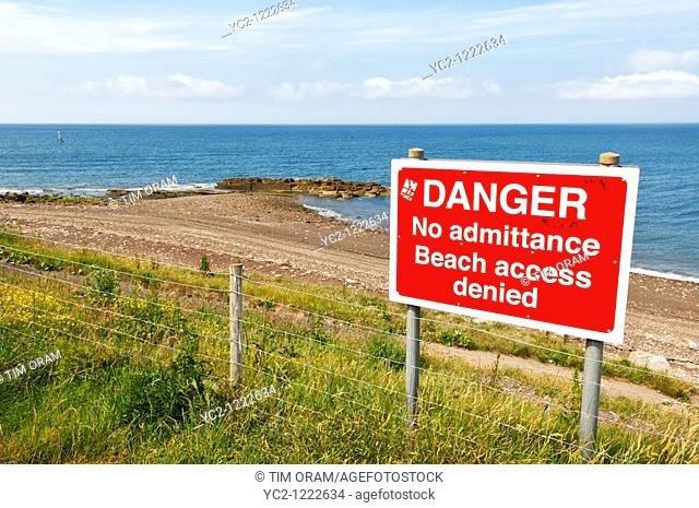 Danger sign on beach near Whitehaven marina and harbour on the west coast of Cumbria , England , Great britain , Uk