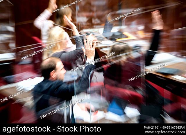 13 October 2021, Bremen: Members of the Bremen Parliament take part in a vote during a plenary session. Photo: Sina Schuldt/dpa