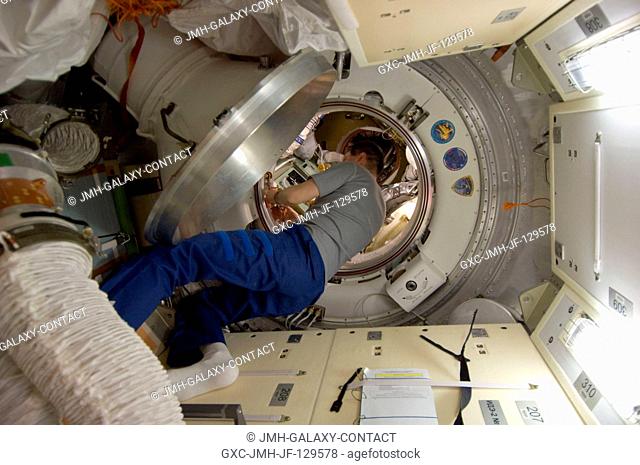 Russian cosmonaut Oleg Kononenko, Expedition 30 flight engineer, works in a hatchway on the International Space Station as crew members prepare to move to the...