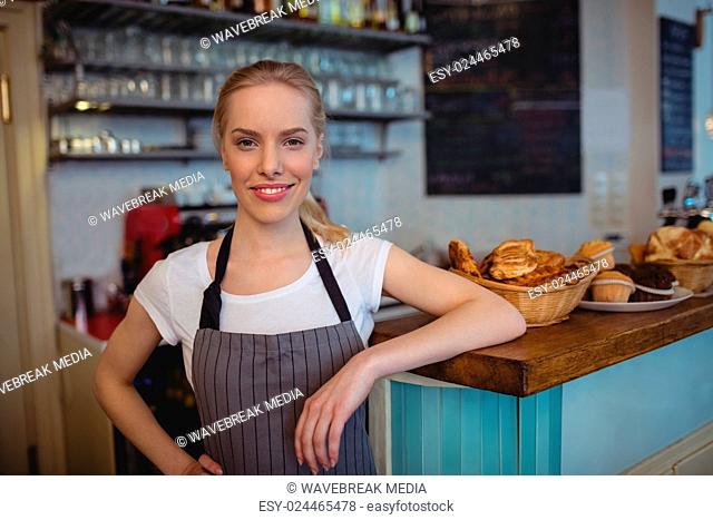 Portrait of confident female barista at cafe
