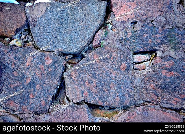 Ancient grunge walls of polished stone background closeup fragment