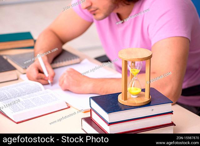 Young student in the classroom at time management concept