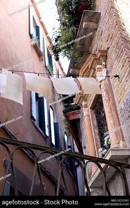 White sheets of paper on a taut line in the old town of Venice