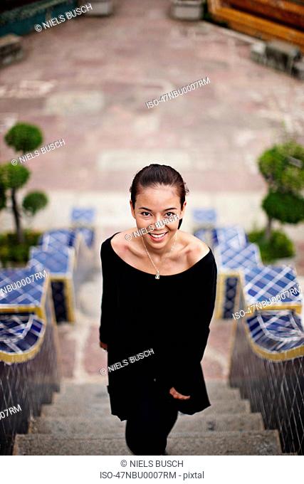 Woman smiling on ornate steps