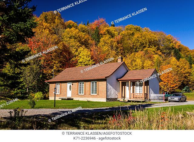 A home with fall foliage color near Saint Brigette de Laval, Quebec, Canada