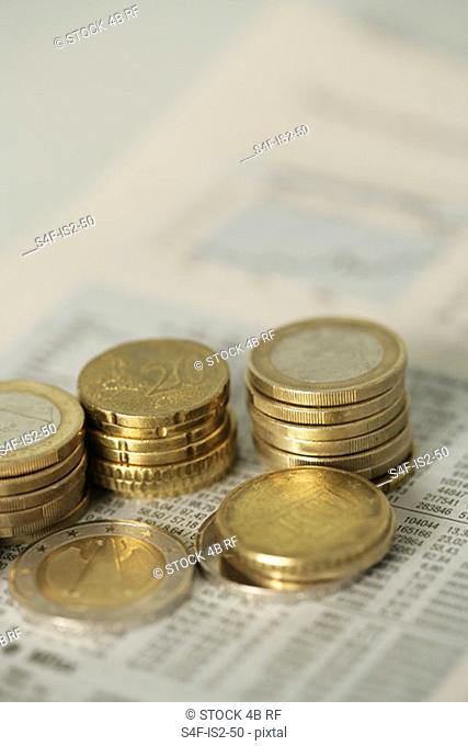1-Euro- and 50-Eurocent coins next to an index showing the cash value, selective focus