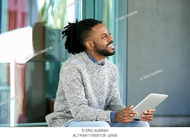Man sitting with digital tablet