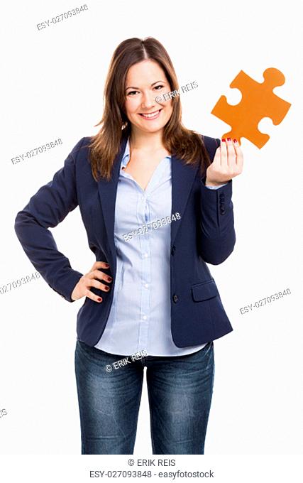 Business woman holding a puzzle piece, isolated over white