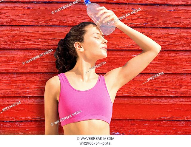 fitness woman with water with red wood background