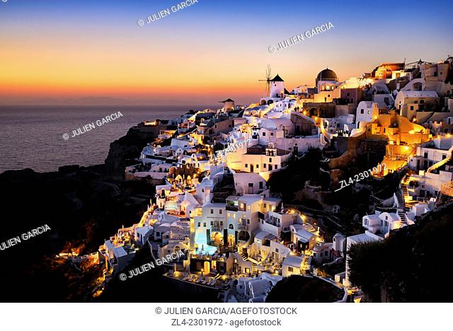 Windmills and village of Oia at sunset. Greece, Greek islands in the Aegean sea, the Cyclades, Santorini island (Thera, Thira)