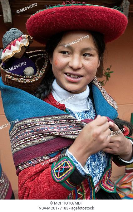 Peru, Chincheros. Peruvian woman in traditional dress at the local artisan coop workshop