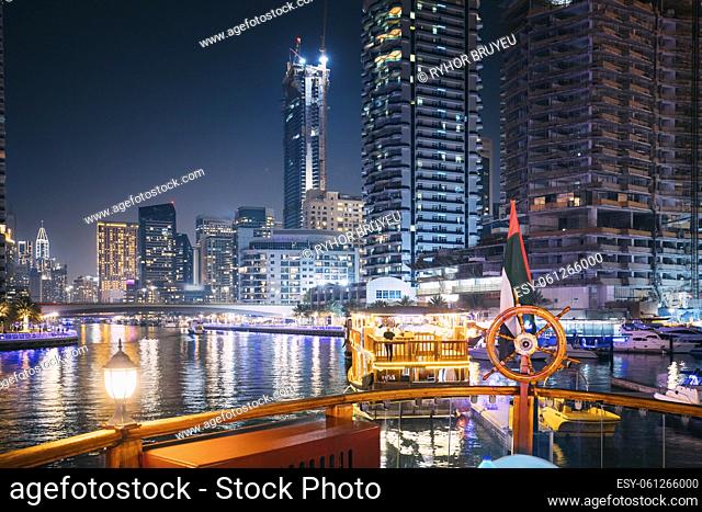 Night Walk On Tourist Boat, Sightseeing Boat Sailing On Dubai Marina. Night View Of Dubai Marina Is District in Dubai, United Arab Emirates