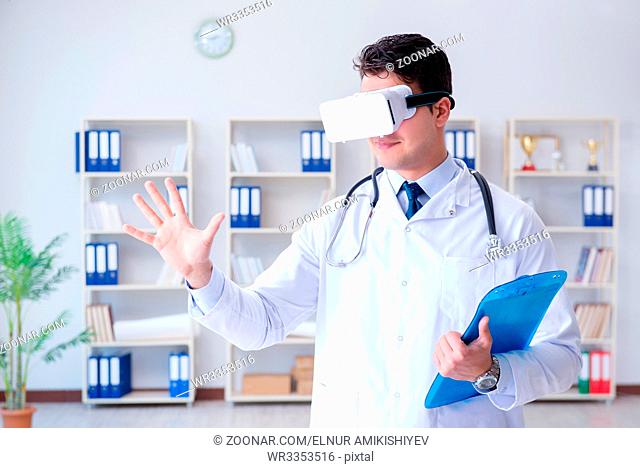 Young doctor with vr virtual reality headset working in the office