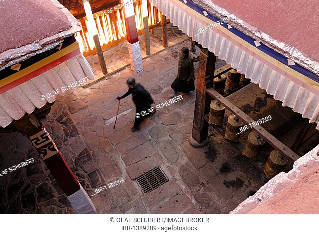 Prayer wheels and Tibetan pilgrims near the Kora, circumambulation, Jokhang Temple, Lhasa, Tibet, China, Asia