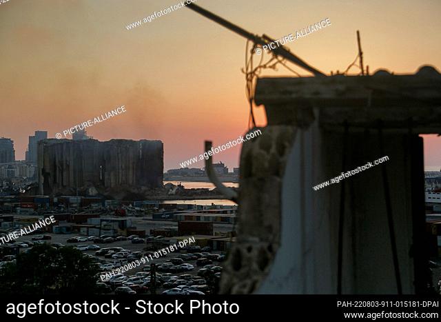 03 August 2022, Lebanon, Beirut: A view of the devastated Beirut port wheat silos during sunset, on the eve of the 2nd anniversary of the blast that ripped...