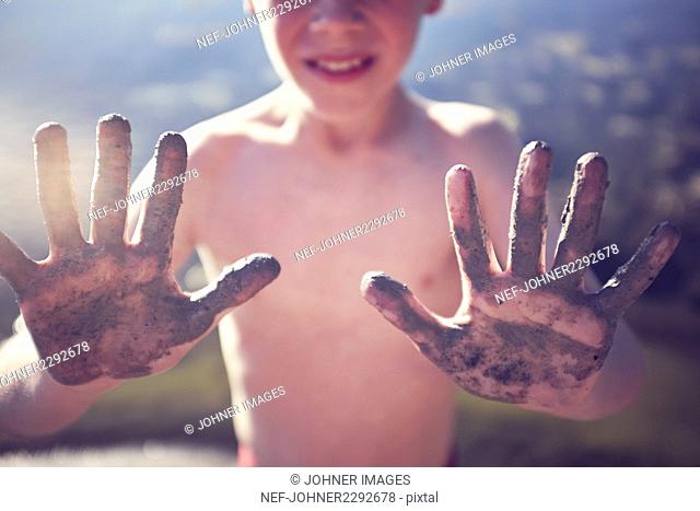 Boy showing dirty hands