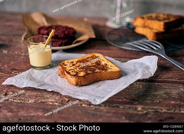 French toast on paper with mayonnaise and a beetroot burger