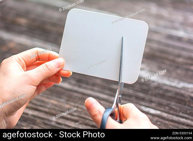woman cutting paper by scissors