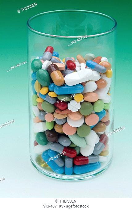 glass filled with pills in different colours and forms. - 03/04/2007