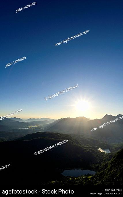 Sun star over Karwendel, Ferchensee and Lautersee, as well as the forested Kranzberg in Werdenfelser Land, on the border with Tyrol/Austria