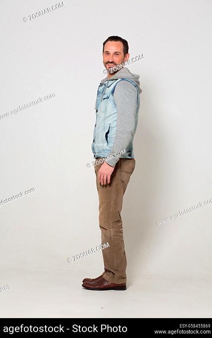 Tall young handsome man in fashion clothes on white background. Sexy man concept