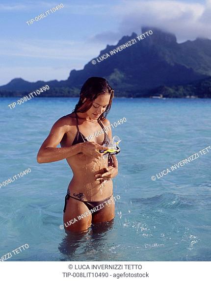 French Polynesia, Bora Bora, girl playing with water