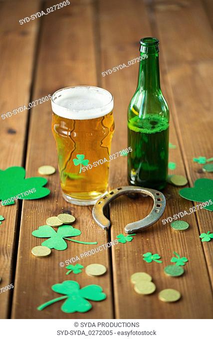 glass of beer, bottle, horseshoe and gold coins
