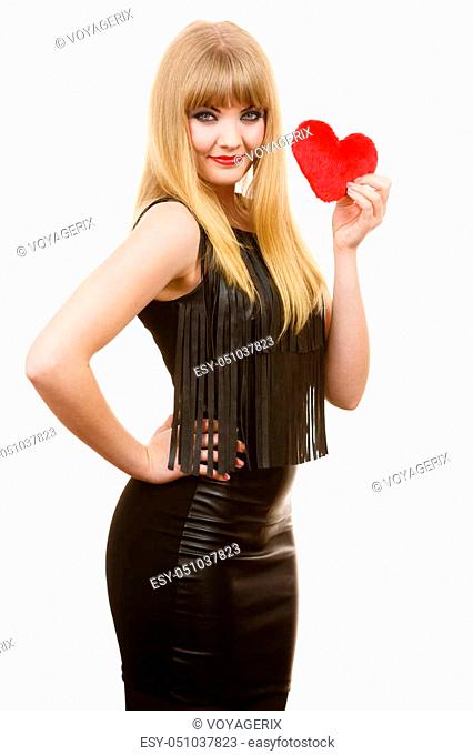 People in love, happiness. Young lady with red heart. Beautiful blonde woman holding ticker. Attractive girl has make up and black outfit