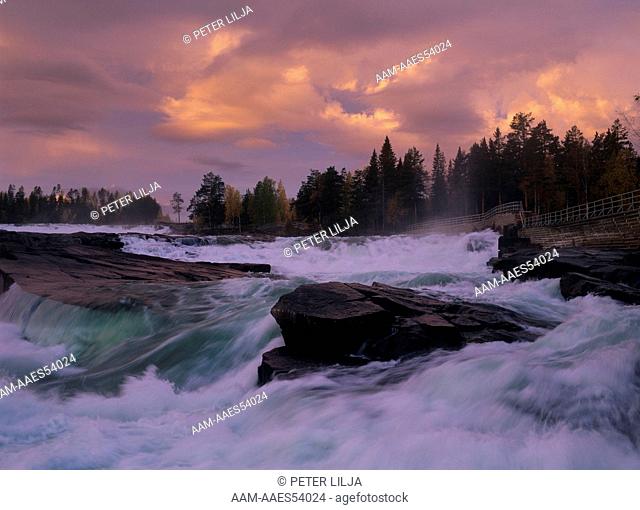 Fast moving Pite River with dramatic Sky in early a.m., Norrbotten, Sweden