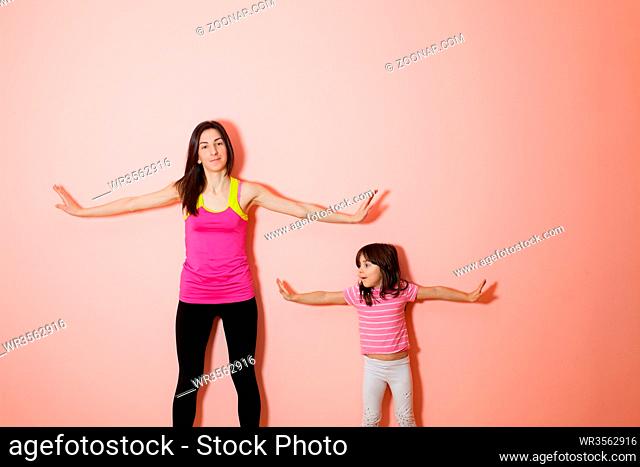 Portrait of child and mother that doing physical exercise together at home