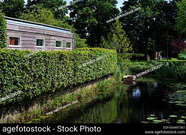 Wooden house and green creek as a background, Barendrecht, South Holland, The Netherlands