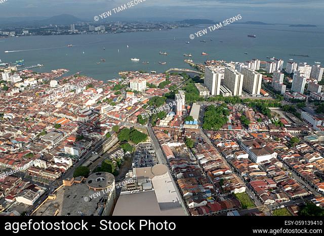 Aerial view Penang Georgertown in evening with shadow of KOMTAR building. Background is Straits of Malacca