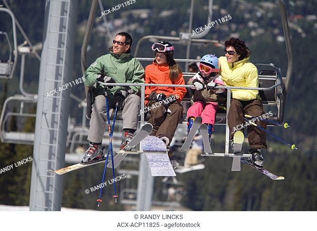 A young family on a chairlift, Whistler Mountain, British Columbia, Canada