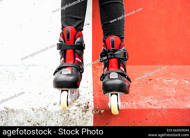 Close-up Of Legs Wearing Roller Skating Shoe, Outdoors urban lifestyle portrait. High quality photo
